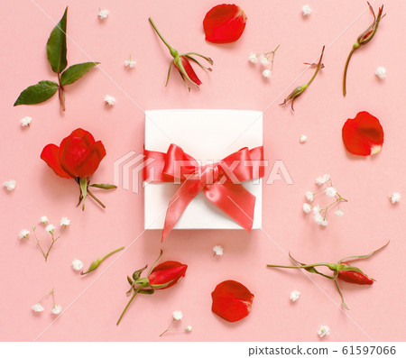 White gift box and flowers on a light pink White gift box and flowers on a light pink 61597066