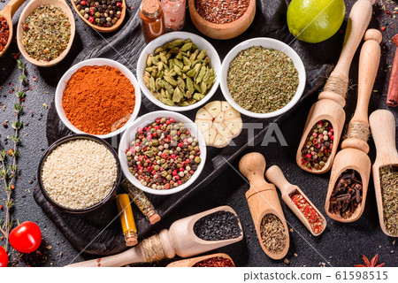 Spices and herbs over black stone background 61598515