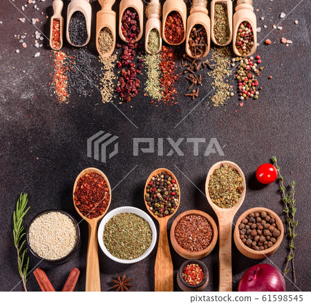 Spices and herbs over black stone background 61598545