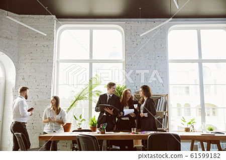 Group of young business professionals having a meeting, creative office Group of young business professionals having a meeting, creative office 61599182
