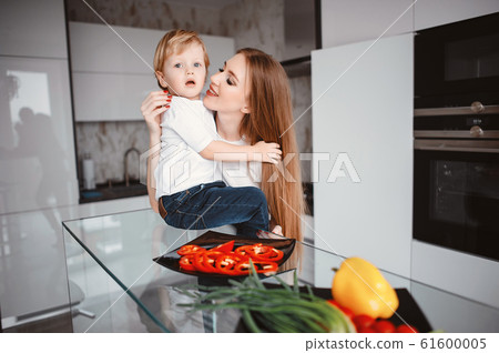 Family prepare the salad in a kitchen Family prepare the salad in a kitchen 61600005