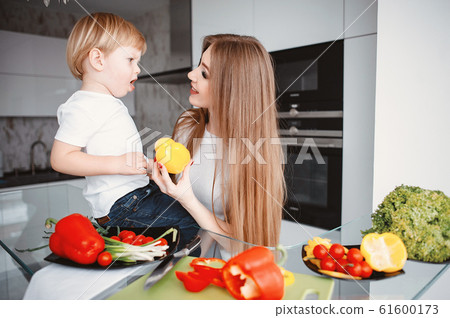 Family prepare the salad in a kitchen 61600173