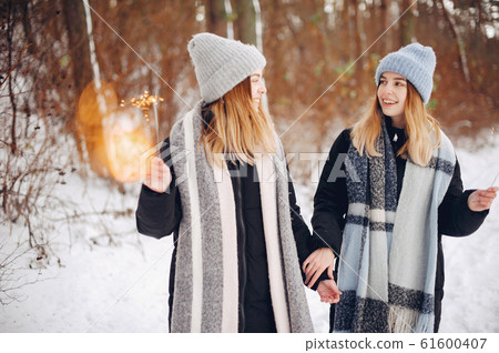 Two cute girls in a winter park Two cute girls in a winter park 61600407