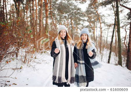Two cute girls in a winter park Two cute girls in a winter park 61600609