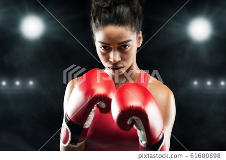 Confident black woman boxer standing in pose, ready to fight 61600898