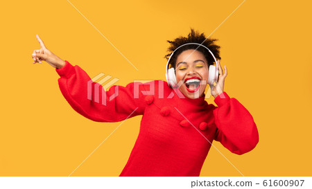 Portrait of happy afro woman enjoying music Portrait of happy afro woman enjoying music 61600907