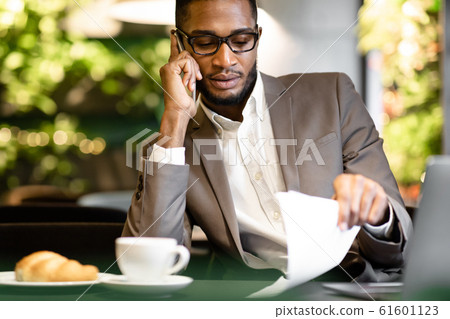 Portrait of afro businessman making phone call Portrait of afro businessman making phone call 61601123