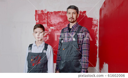 A little boy and his father standing in the room - painting walls 61602006