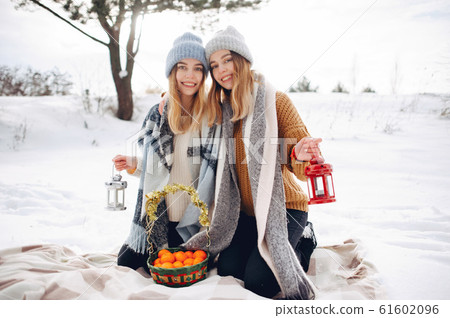 Two cute girls in a winter park 61602096