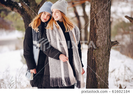 Two cute girls in a winter park Two cute girls in a winter park 61602184