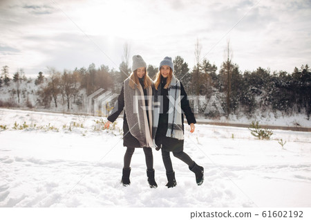 Two cute girls in a winter park Two cute girls in a winter park 61602192