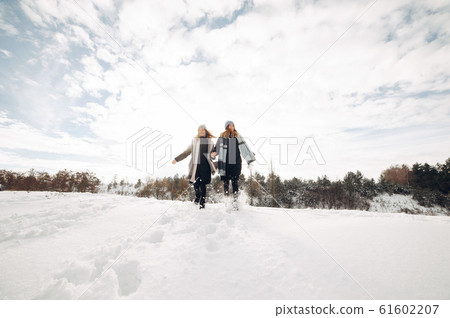 Two cute girls in a winter park Two cute girls in a winter park 61602207