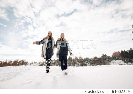 Two cute girls in a winter park Two cute girls in a winter park 61602209