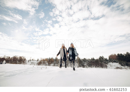 Two cute girls in a winter park Two cute girls in a winter park 61602253