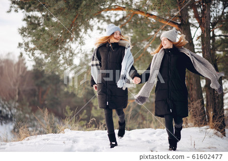 Two cute girls in a winter park 61602477