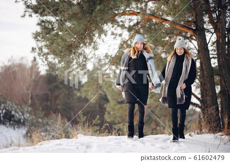 Two cute girls in a winter park 61602479