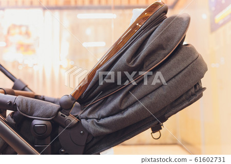 The child sleeps in the stroller. Baby carriage stands on the bank of a frozen. 61602731