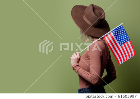 Beautiful cowgirl in a hat with United States of America flag Beautiful cowgirl in a hat with United States of America flag 61603997