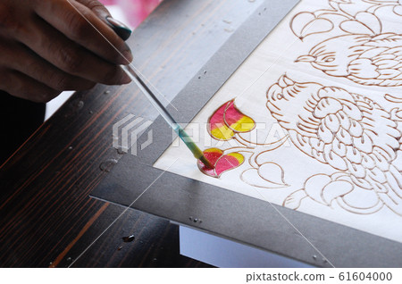 Malaysian draw batik or batik canting. The color control by wet wax that drawn earlier. Malaysian draw batik or batik canting. The color control by wet wax that drawn earlier. 61604000