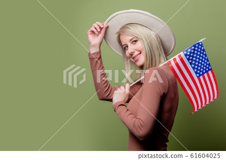 Beautiful cowgirl in a hat with United States of America flag 61604025