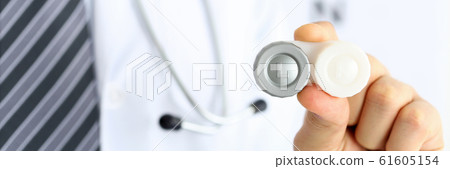 Male doctor hands giving pair of contact lens in case 61605154