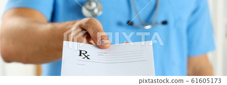 Male medicine doctor in blue uniform hold and give prescription Male medicine doctor in blue uniform hold and give prescription 61605173