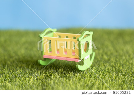 Baby crib stands on the grass. Baby crib stands on the grass. 61605221