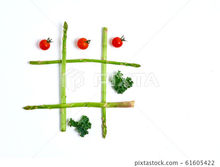 tic tac toe with food, asparagus kale, tomato, top view 61605422