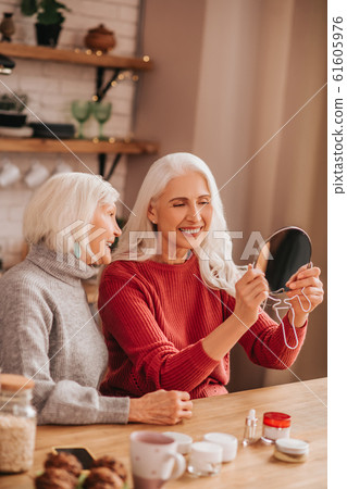 Two good-looking elderly women looking happy and involved 61605976