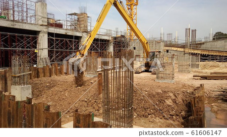 Excavators machine is heavy construction machine used excavate soil at the construction. Powered by long hydraulic arm with bucket. Operate by workers.  61606147