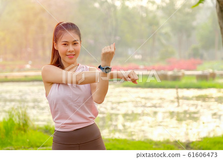 Portrait of young beautiful sport girl action of arms stretch 61606473