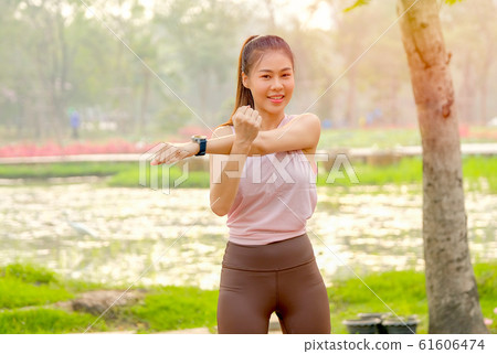 Portrait of young beautiful sport girl action of arms stretch 61606474