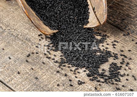 Black cumin seeds on a vintage scoop Black cumin seeds on a vintage scoop 61607107