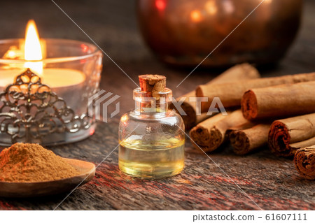 A bottle of cinnamon essential oil with true cinnamon 61607111