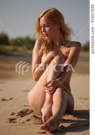 Beautiful girl model on sandy beach of the sea on 61607888