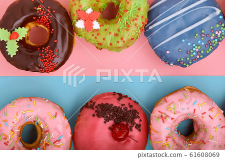 Sweet donuts on a blue and pink background. Assorted donuts, border color blue pink background. Sweet donuts on a blue and pink background. Assorted donuts, border color blue pink background. 61608069