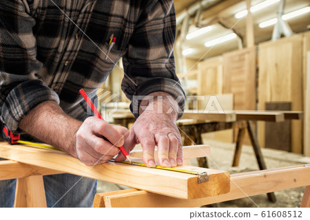 Carpenter at work on wooden boards. Carpentry. Carpenter at work on wooden boards. Carpentry. 61608512