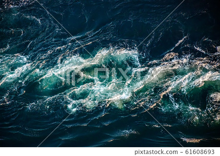 Waves of water of the river and the sea meet each 61608693