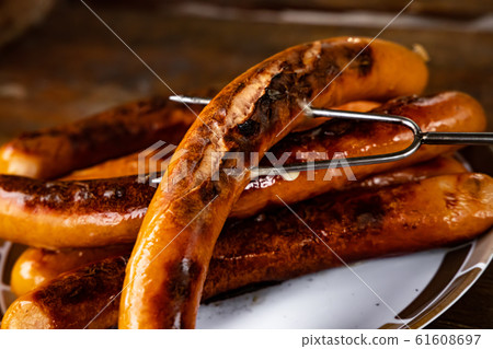 Grilled sausages on wooden board Grilled sausages on wooden board 61608697