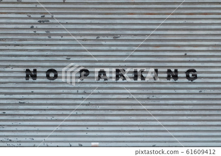 closed shutter on store or shop front saying no parking 61609412