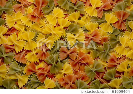 Colored italian pasta butterflies. Creative food background. Colored italian pasta butterflies. Creative food background. 61609464