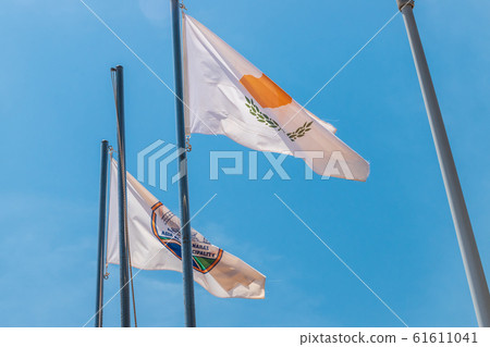 The national flag of Cyprus. Light flag on the flagpole. The summer wind flutters the flag. The national flag of Cyprus. Light flag on the flagpole. The summer wind flutters the flag. 61611041