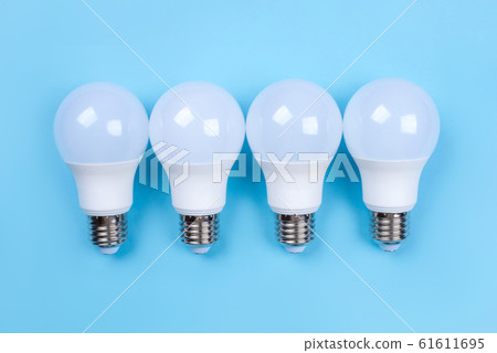 Four LED bulbs on blue background. Saving energy concept. Four LED bulbs on blue background. Saving energy concept. 61611695
