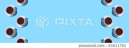 Frame of cups of black coffee or tea on a blue background. 61611782