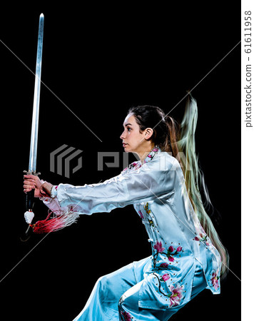 woman Tai Chi Chuan Tadjiquan posture isolated black background light painting woman Tai Chi Chuan Tadjiquan posture isolated black background light painting 61611958