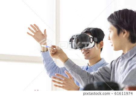 Two men who experience the latest 5G technology in 3D with VR goggles and incorporate it into business 61611974