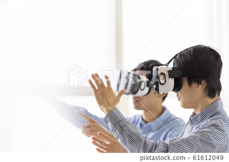 Two men who experience 3D with the latest 5G technology with VR goggles and incorporate it into architectural design 61612049
