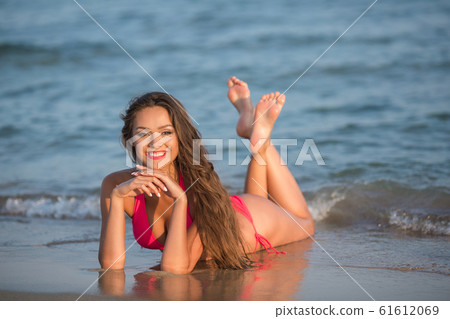 Beautiful girl in a pink swimsuit. 61612069