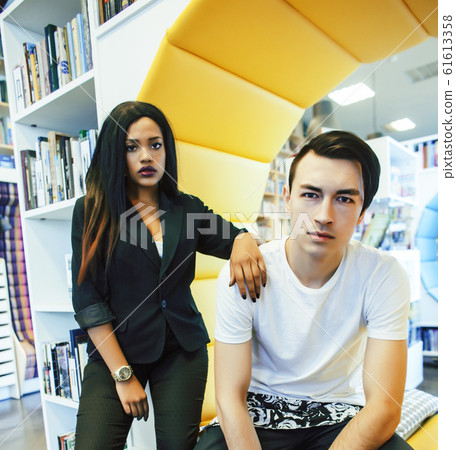 couple students in univercity library, looking book, preparing to exam, having fun, making selfie, lifestyle people concept couple students in univercity library, looking book, preparing to exam, having fun, making selfie, lifestyle people concept 61613358