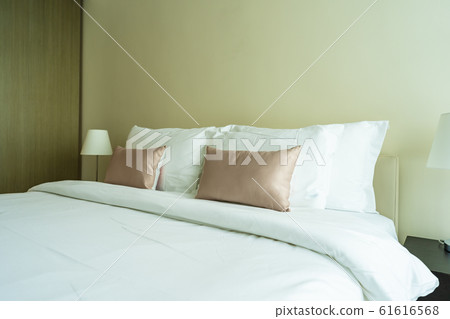 White comfortable pillow on bed decoration interior 61616568